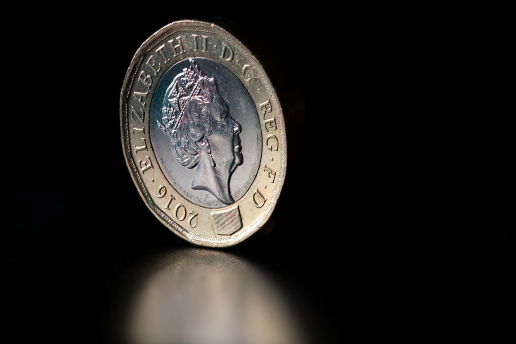 pound coin on a black background